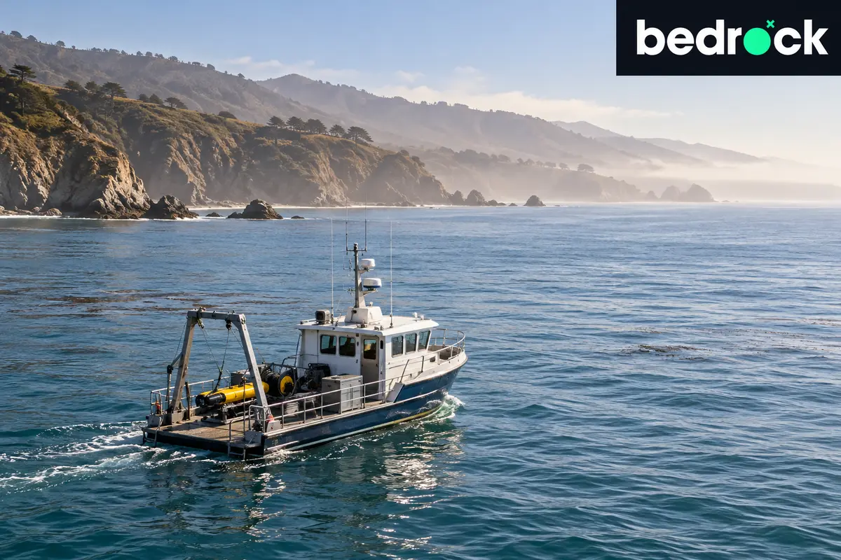 Small survey vessel beside a Pacific coastline